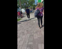 Woman brushes wig on bench 