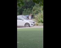 Two women white dress dances parking lot