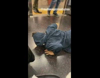 Guy blue jacket humps the ground on subway train