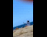 Woman blue bucket hat selfie at beach