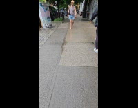 Man gray top walk barefoot on sidewalk