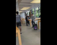 Man sing with microphone speakers inside apple store