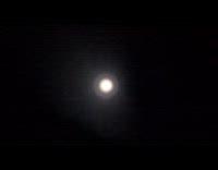 Rainbow ring around moon on night sky