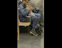 Man holds cigarettes inside the train at subway NY  