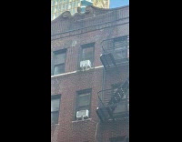 Rooftop building flooded leaks down the wall
