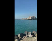 Man flexing hard on beach