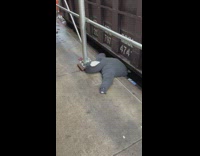 grey hoodie stuffed to look like human under trash can