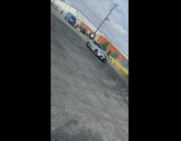 Group of people stand inside car donut