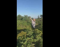 Woman white dress vegetable throw grass photographer