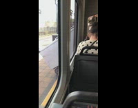 Guy wheels white refrigerator off train  