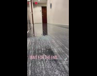 Guy shows his flooded apartment hallway
