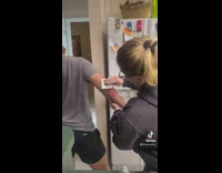 Guy screams as woman helps him patch a scratch