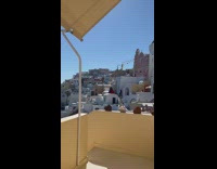Two women in red and blue dress at Santorini