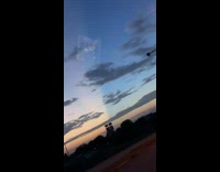 Sunset sky with line of yellow and blue road trip