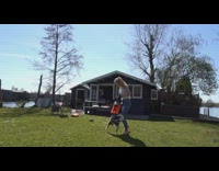 Girl does flips grass black white dog 