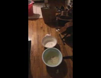 Girl uses bucket to catch leaking water 