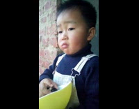 Young boy blue sweater eat grapes bowl