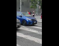 Girl red dress dance on pedestrian crossing