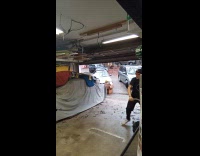 Boy scooter flip trick success in garage