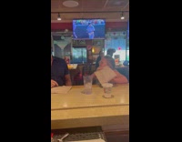 Man and Little girl plays the tortilla challenge at a bar