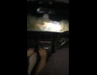 Guys drive car bumpy narrow road beer