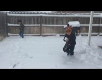 Little boy kid throws snowball hits camera