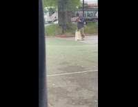 Guy puts bird in bag 