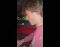 Guy asks friend for tune in car and music plays