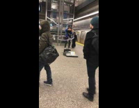 Girl plays the violin and hula hoops in subway station