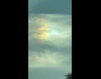 Rainbow colors on the clouds in sky