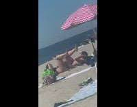 Two girls resistance band around legs beach
