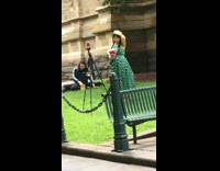 Polka dot dress lady brings tripod for photo 