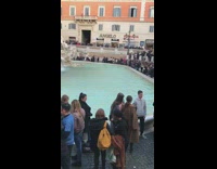 Woman takes picture at Trevi fountain