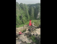 Red dress girl poses stairs railing field 