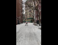 Man skiis down walkway between buildings
