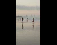 Woman yoga squat at the beach at sunset