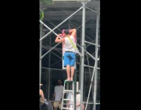 Man covers schedule of no standing sign 