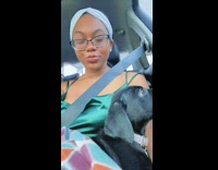 Woman taking selfie video with dog on car