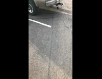 Two guys stand next to white truck with Confederate flag and Blue lives matter flag in parking lot