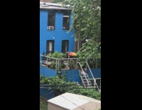 Guy uses broom to sweep rain water