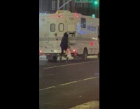 Guy on roller skates holds onto back of verizon truck