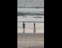 Woman see-thru shiny beach dress for photoshoot