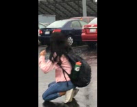 girl in pink slips and falls in rain water