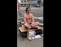 Guy sits at street for engagement fund
