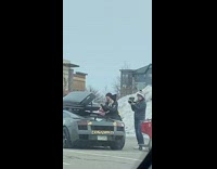 Couple put cash on luggage over car