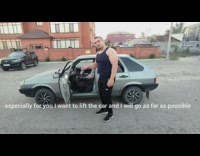 Man in tank top lifts car and moves it sideways