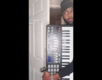 Guy plays music on midi keyboard