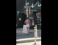 Guy walks around wearing white diaper deli 
