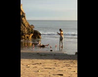 Woman dance with candles on the beach