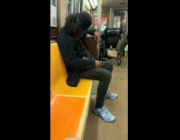 Man in train with pigeon in pocket